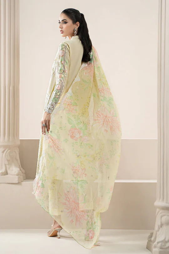 Woman wearing a light green floral saree in an elegant indoor setting