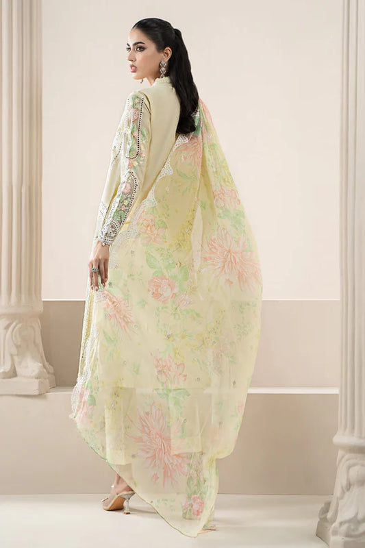 Woman wearing a light green floral saree in an elegant indoor setting