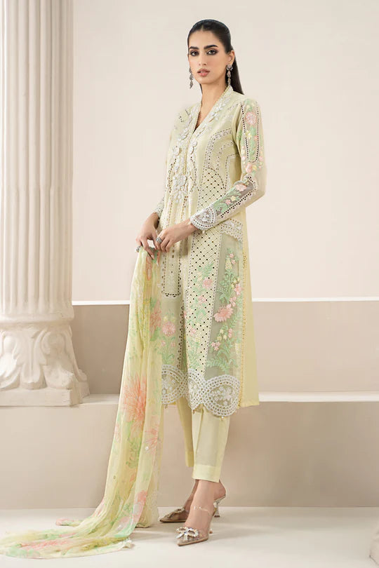 Woman wearing a light green embroidered outfit in an elegant setting