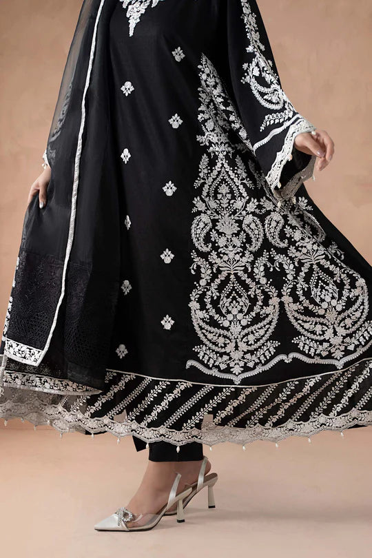 Black traditional outfit with white embroidery on a beige background
