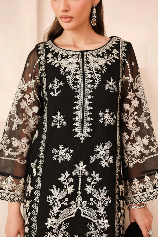 Black embroidered dress with white patterns on a neutral background