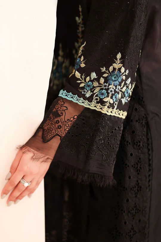 Black embroidered garment with floral patterns on a white background