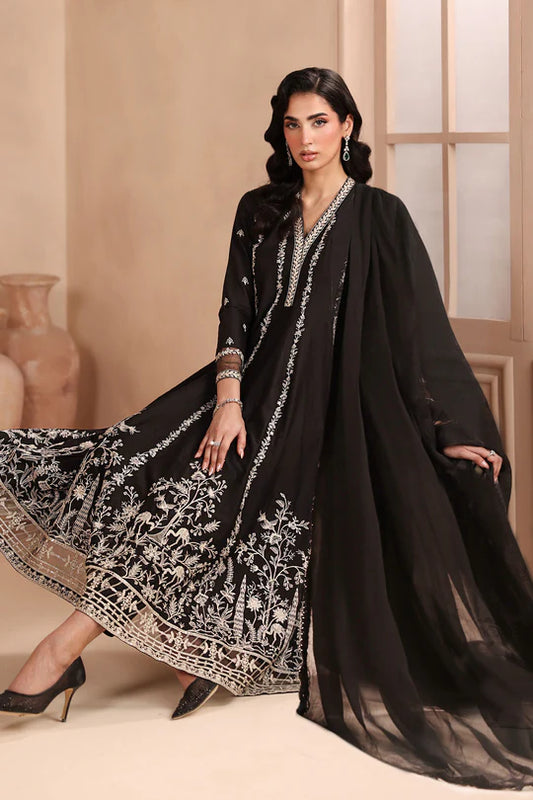 Woman wearing a black embroidered outfit with a beige background