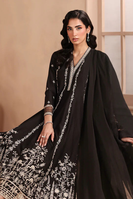 Woman wearing a black traditional outfit with white embroidery against a beige background