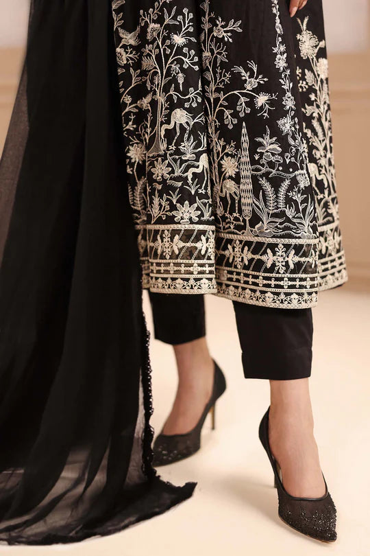 Black embroidered outfit with sheer black dupatta and high-heeled shoes on a neutral background