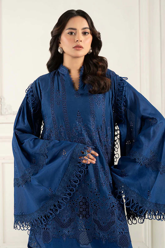 Woman wearing a blue lace dress against a white background