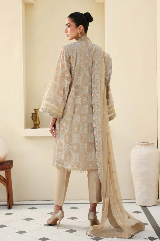 Woman in a beige traditional outfit with a matching dupatta in a room.