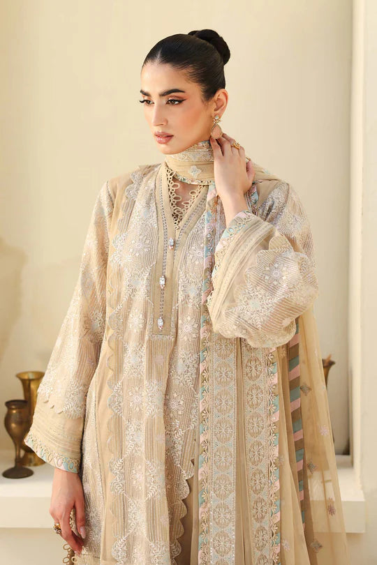 Woman wearing a beige embroidered traditional outfit with a plain background