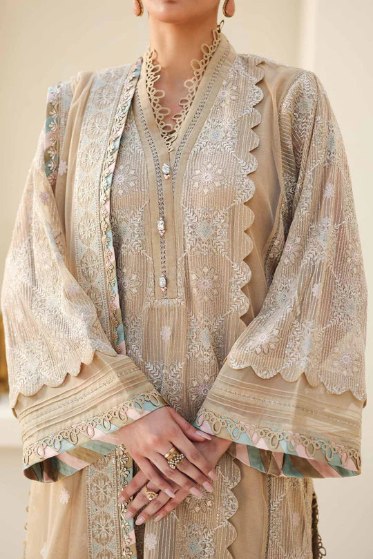 Beige embroidered traditional outfit with jewelry on a neutral background