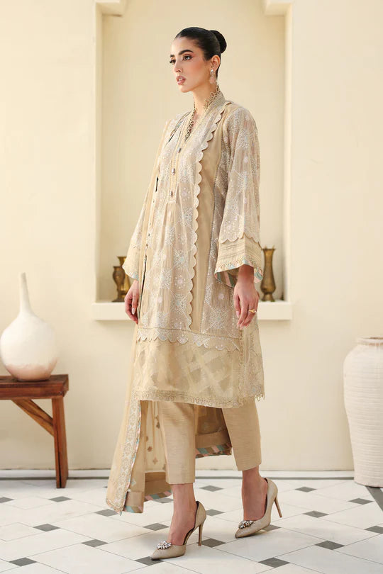 Woman wearing a beige traditional outfit in a decorated room.
