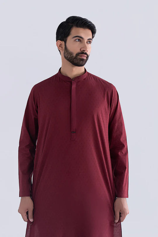 Man wearing a maroon traditional outfit on a white background