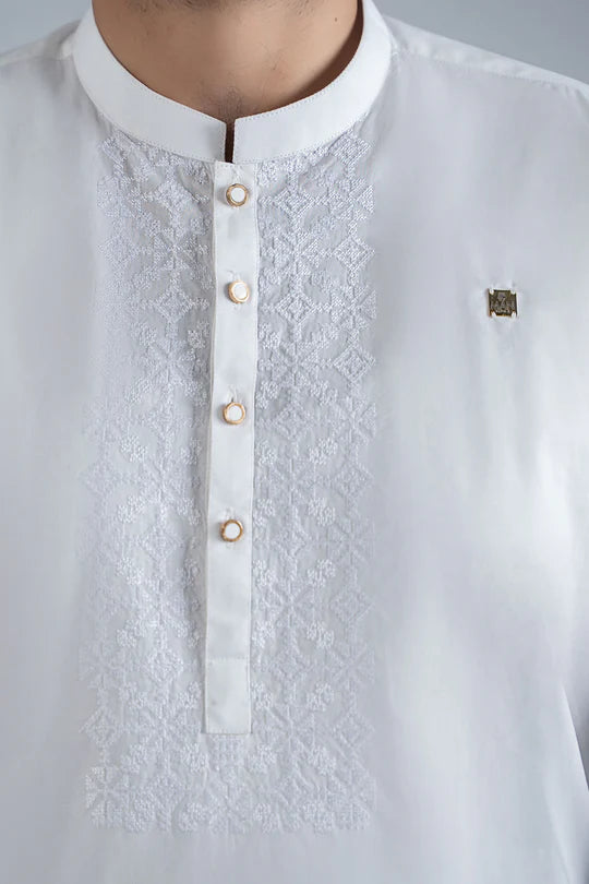 White embroidered shirt with buttons on a gray background