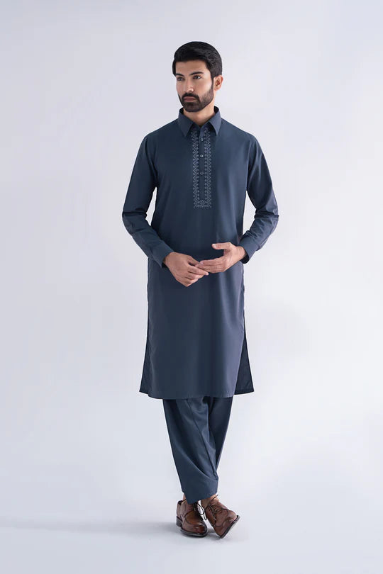 Man wearing a dark gray kurta with embroidery on a white background