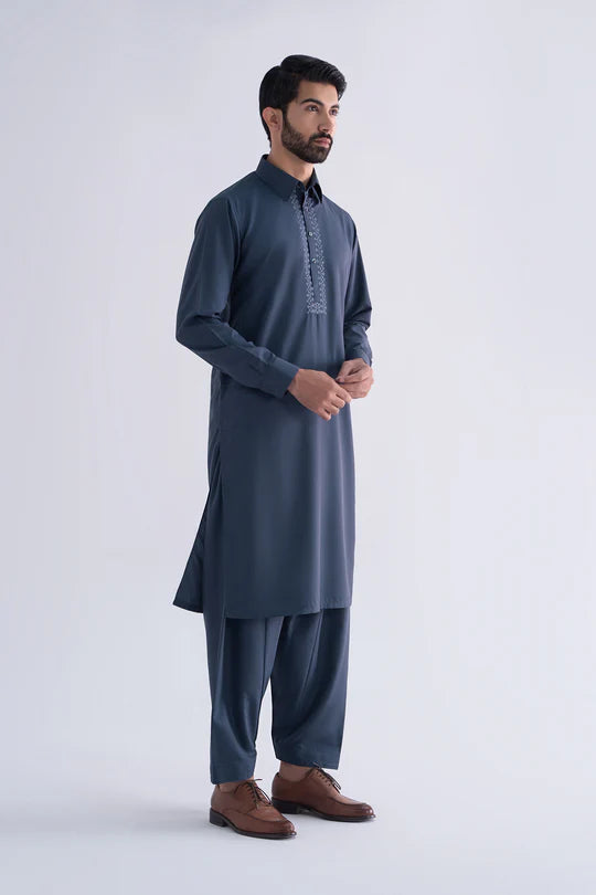 Man wearing a blue kurta with pants on a white background