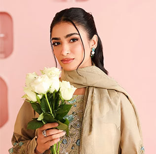 Woman holding a bouquet of white roses against a pink background